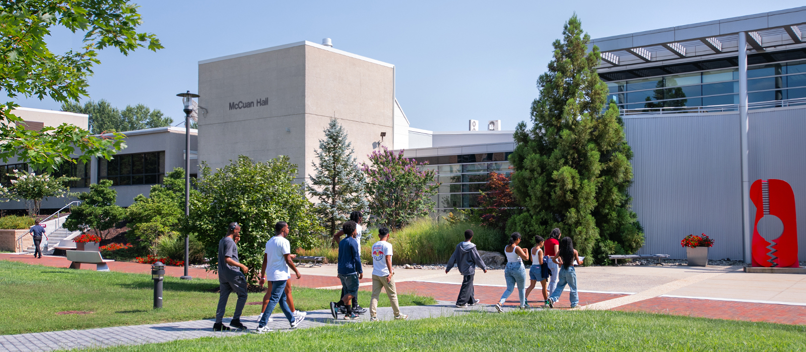 Prospective students walk across Howard Community College's campus during a guided campus visit.
