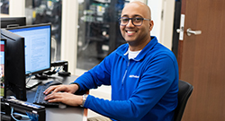 Student working at a computer, representing student support for Fast Track Career Credential programs.