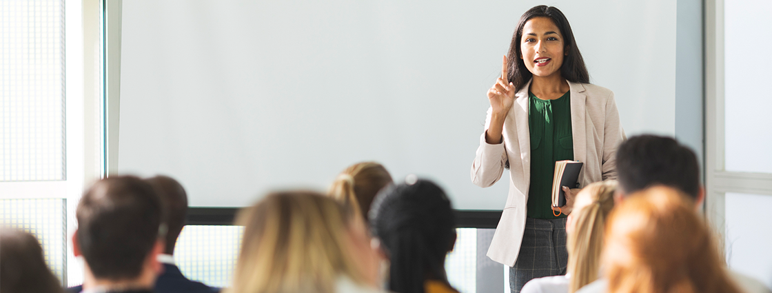 Businesswoman holding a speech in a classroom setting.