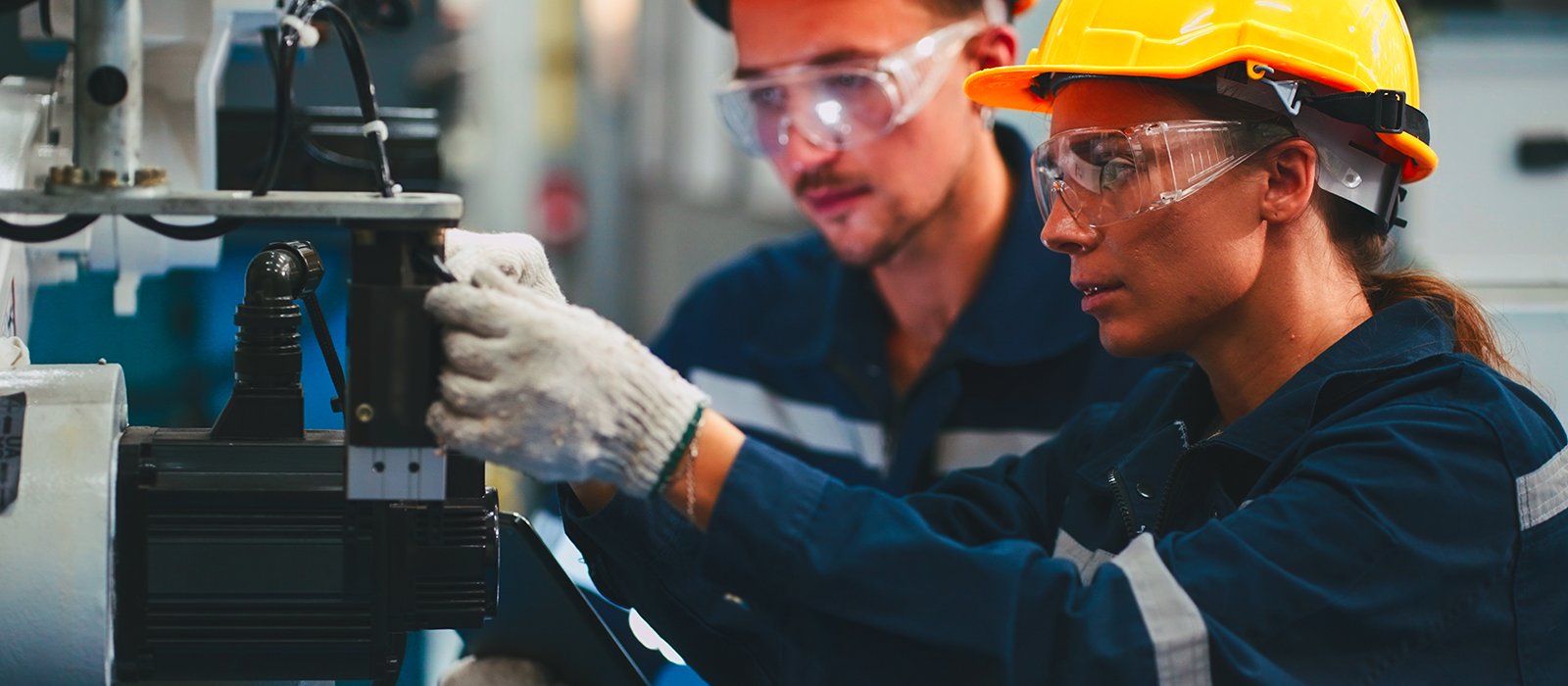 Students receive hands-on manufacturing technology training while operating and maintaining industrial equipment in a laboratory setting.